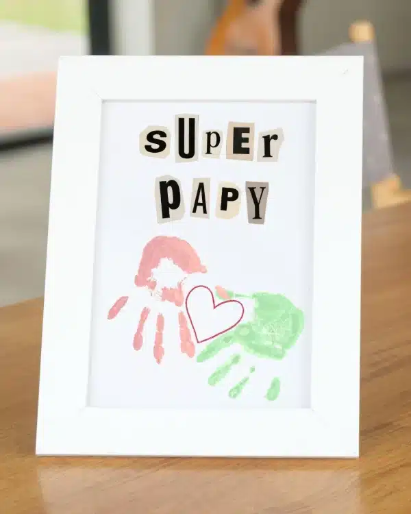 cadeau fait main pour grand-père avec deux empreintes de main d'enfants, un coeur dessiné et une inscription "super papy"